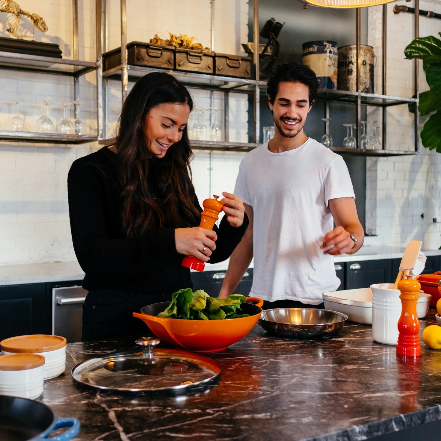 Community members collaborating in a contemporary kitchen, sharing recipes and techniques